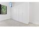 Bright bedroom boasts a wall of built-in storage and a large window at 656 Garden District Dr, Charlotte, NC 28202