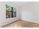 Bright bedroom with hardwood floors and a large window showcasing the outdoor greenery at 656 Garden District Dr, Charlotte, NC 28202
