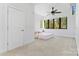 Bright bedroom with large windows, a ceiling fan, and neutral carpet flooring at 656 Garden District Dr, Charlotte, NC 28202