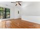 Upstairs bedroom with hardwood floors and a window showcasing exterior views at 656 Garden District Dr, Charlotte, NC 28202