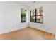Spacious bedroom with hardwood floors and two windows offering exterior views at 656 Garden District Dr, Charlotte, NC 28202