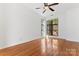 Bright bedroom featuring a ceiling fan and hardwood floors, with a large window at 656 Garden District Dr, Charlotte, NC 28202