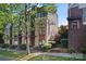 Modern townhome with a brick and beige exterior and large windows and a tree at 656 Garden District Dr, Charlotte, NC 28202