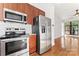Modern kitchen with stainless steel appliances, wood cabinets, and hardwood floors at 656 Garden District Dr, Charlotte, NC 28202