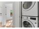Modern laundry area featuring a stacked washer and dryer unit at 656 Garden District Dr, Charlotte, NC 28202