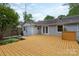 Spacious back deck perfect for entertaining with French doors and well maintained landscaping and a painted brick exterior at 6701 Highbrook Dr, Charlotte, NC 28212