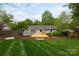 Beautifully landscaped backyard featuring a new wooden deck, perfect for outdoor entertaining at 6701 Highbrook Dr, Charlotte, NC 28212
