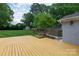 View of the home's backyard, with a spacious lawn, wooden fence and shed that provides ample outdoor space at 6701 Highbrook Dr, Charlotte, NC 28212