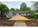 Spacious back yard with a well maintained deck and a beautifully painted brick exterior home with landscaped backyard at 6701 Highbrook Dr, Charlotte, NC 28212