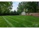 A full view of the home's backyard, with a spacious lawn and a shed that provides ample outdoor space at 6701 Highbrook Dr, Charlotte, NC 28212
