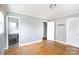 Neutral bedroom with hardwood floors, an adjacent bathroom, and large closet at 6701 Highbrook Dr, Charlotte, NC 28212