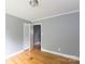 Bedroom with hardwood floors, neutral paint, featuring closet and doorway at 6701 Highbrook Dr, Charlotte, NC 28212