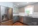 Bright kitchen with stainless steel appliances, granite countertops, and white subway tile backsplash at 6701 Highbrook Dr, Charlotte, NC 28212