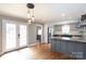 Open concept eat-in kitchen features stainless steel appliances and access to the outdoor living space at 6701 Highbrook Dr, Charlotte, NC 28212