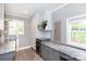 Kitchenette with wine cooler, gray cabinets, white countertops and stainless microwave at 6701 Highbrook Dr, Charlotte, NC 28212