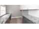 Spacious laundry room offering gray cabinets, white countertops and tile backsplash, and a window at 6701 Highbrook Dr, Charlotte, NC 28212