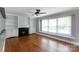 Bright living room with hardwood floors, fireplace and built-in shelving on either side at 6701 Highbrook Dr, Charlotte, NC 28212