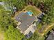 Stunning aerial view of a home with an inground pool and a lush green yard at 7181 Windy Ridge Dr, Iron Station, NC 28080