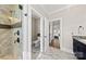 Luxurious bathroom with a glass shower and multiple entryways including bedroom and toilet area at 7181 Windy Ridge Dr, Iron Station, NC 28080