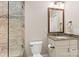 Well-lit bathroom featuring a granite countertop vanity and a glass enclosed walk-in shower at 7181 Windy Ridge Dr, Iron Station, NC 28080