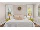 Comfortable bedroom with bedside lamps, bright windows, and decorative pillows on a comfy bed at 7181 Windy Ridge Dr, Iron Station, NC 28080