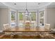 Dining room with a large table surrounded by windows with outdoor views at 7181 Windy Ridge Dr, Iron Station, NC 28080