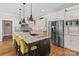 Island with seating, stone countertops, stainless appliances, and custom cabinets create this luxurious kitchen at 7181 Windy Ridge Dr, Iron Station, NC 28080