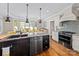 Kitchen island with seating, granite countertop, stainless appliances, and stove top at 7181 Windy Ridge Dr, Iron Station, NC 28080