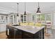 Kitchen island with seating, granite countertop, stainless appliances, and windows at 7181 Windy Ridge Dr, Iron Station, NC 28080