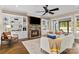 Bright and airy living room with stone fireplace and views of the outdoor pool area at 7181 Windy Ridge Dr, Iron Station, NC 28080
