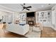 Living room with cozy fireplace, built-in shelving, ceiling fan and large comfortable sofas at 7181 Windy Ridge Dr, Iron Station, NC 28080