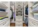 Well-organized walk-in closet with custom shelving and drawers offers ample storage space at 7181 Windy Ridge Dr, Iron Station, NC 28080