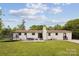 Rear exterior view of home featuring a patio with outdoor seating and a trampoline in the backyard at 7200 Monroe Rd, Charlotte, NC 28212