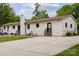 This backyard boasts a large concrete patio, lush green lawn, and a stylish white brick exterior with dark trim accents at 7200 Monroe Rd, Charlotte, NC 28212