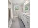 Bright bathroom featuring a double vanity, framed mirror, and a shower with white subway tile at 7200 Monroe Rd, Charlotte, NC 28212