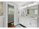 Bright bathroom featuring a double vanity, framed mirror, and a view into the toilet room at 7200 Monroe Rd, Charlotte, NC 28212