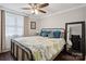 Inviting bedroom showcases a ceiling fan, large window, and a bed with patterned bedding at 7200 Monroe Rd, Charlotte, NC 28212