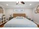 Bright bedroom boasts a comfortable bed, ceiling fan, and matching nightstands with lamps at 7200 Monroe Rd, Charlotte, NC 28212