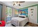 Unique bedroom with a cartoon mural wall, a ceiling fan, and a double window at 7200 Monroe Rd, Charlotte, NC 28212