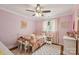 Cozy bedroom with pink walls, a chevron patterned rug, and a vintage metal bed frame at 7200 Monroe Rd, Charlotte, NC 28212