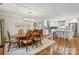 The dining room is open to the kitchen with hardwood floors, and a stylish light fixture at 7200 Monroe Rd, Charlotte, NC 28212
