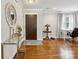 Inviting foyer with hardwood floors, decorative mirror, glass table, and a modern front door at 7200 Monroe Rd, Charlotte, NC 28212