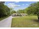 Well-manicured lawn and long driveway leading to a charming single-story home at 7200 Monroe Rd, Charlotte, NC 28212