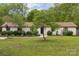 Charming single-story home with mature trees and landscaped front yard at 7200 Monroe Rd, Charlotte, NC 28212