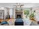 Inviting living room featuring a fireplace, ceiling fan, and sliding door access to the backyard at 7200 Monroe Rd, Charlotte, NC 28212