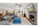Open concept living room with a large sectional sofa, fireplace, and connected kitchen and dining area at 7200 Monroe Rd, Charlotte, NC 28212