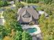 Aerial view of a gorgeous property with a pool, screen porch and ample yard space at 7311 Barrington Ridge Dr, Fort Mill, SC 29707