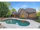 Gorgeous backyard with a swimming pool, outdoor kitchen, and a covered patio perfect for entertaining guests at 7311 Barrington Ridge Dr, Fort Mill, SC 29707