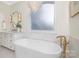 This is an elegant bathroom with a soaking tub, marble accents, and modern lighting at 7311 Barrington Ridge Dr, Fort Mill, SC 29707
