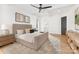 This spacious bedroom features a neutral color palette, tray ceiling and wood floors at 7311 Barrington Ridge Dr, Fort Mill, SC 29707